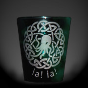 Etched shot glass of striking green in honor of Cthulhu below